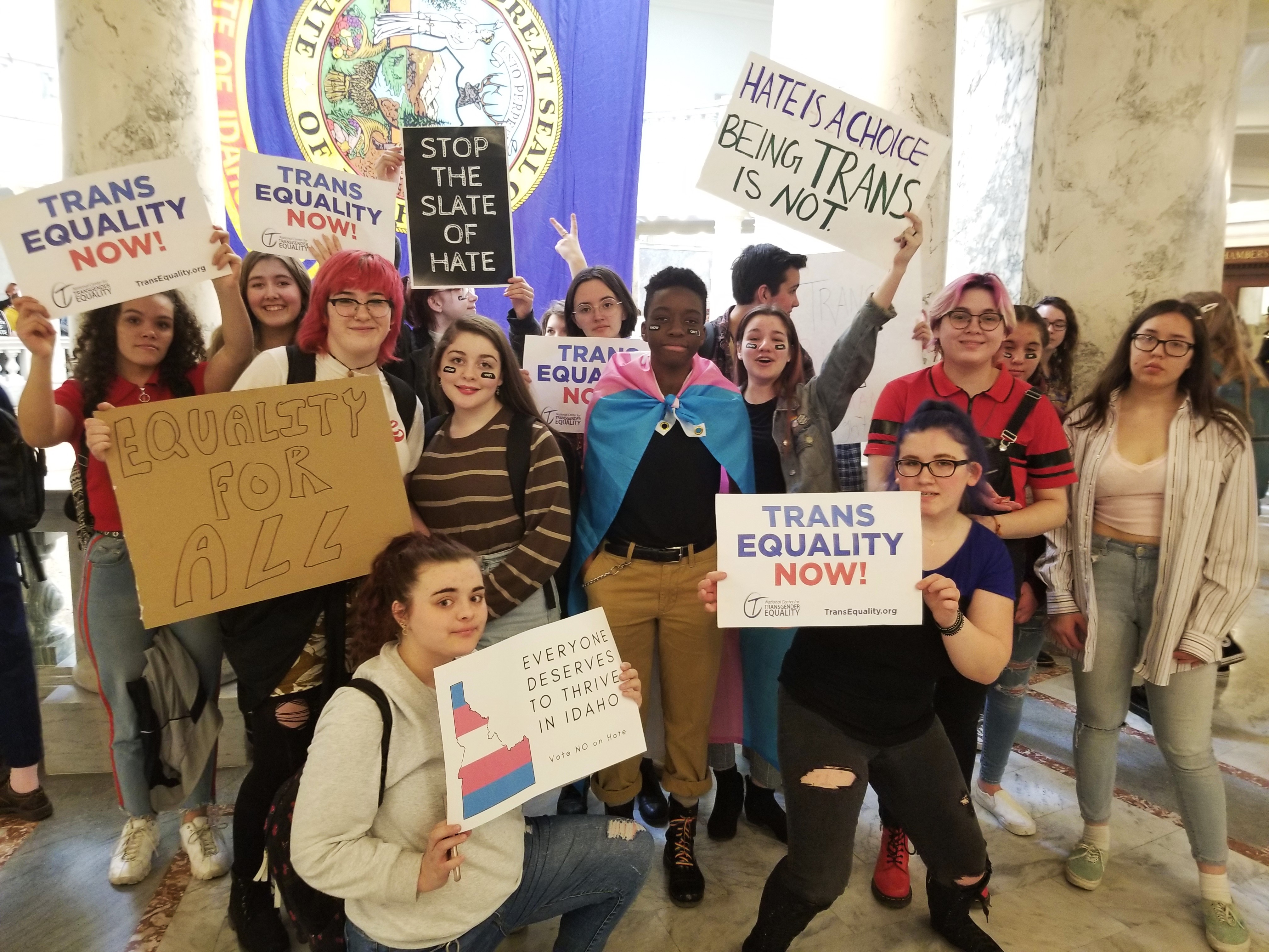 Trans youth holding signs at Idaho capitol