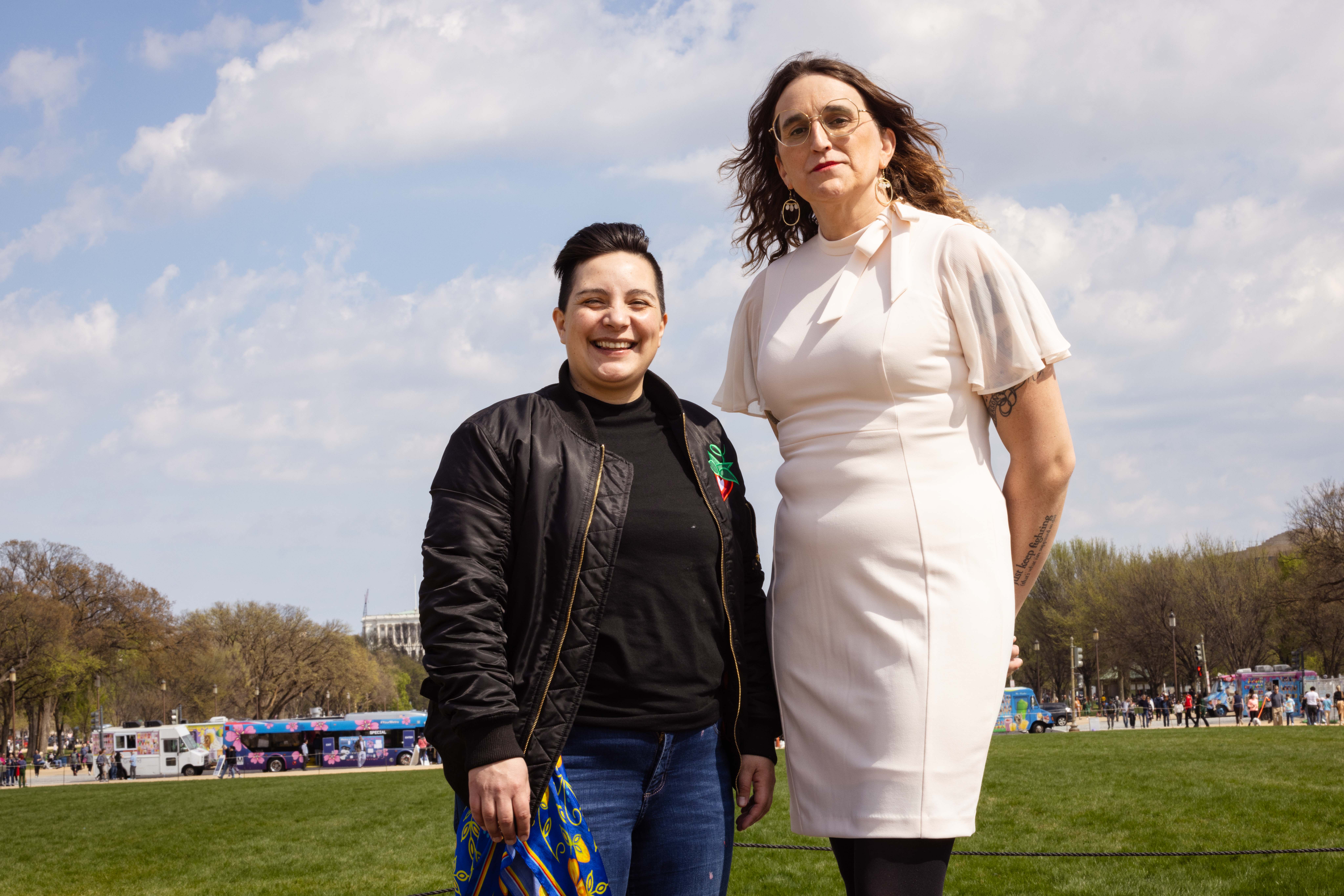 Nonbinary two-spirit legislator Liish Kozlowski and transgender woman legislator Leigh Finke stand in front of the US Capitol. 