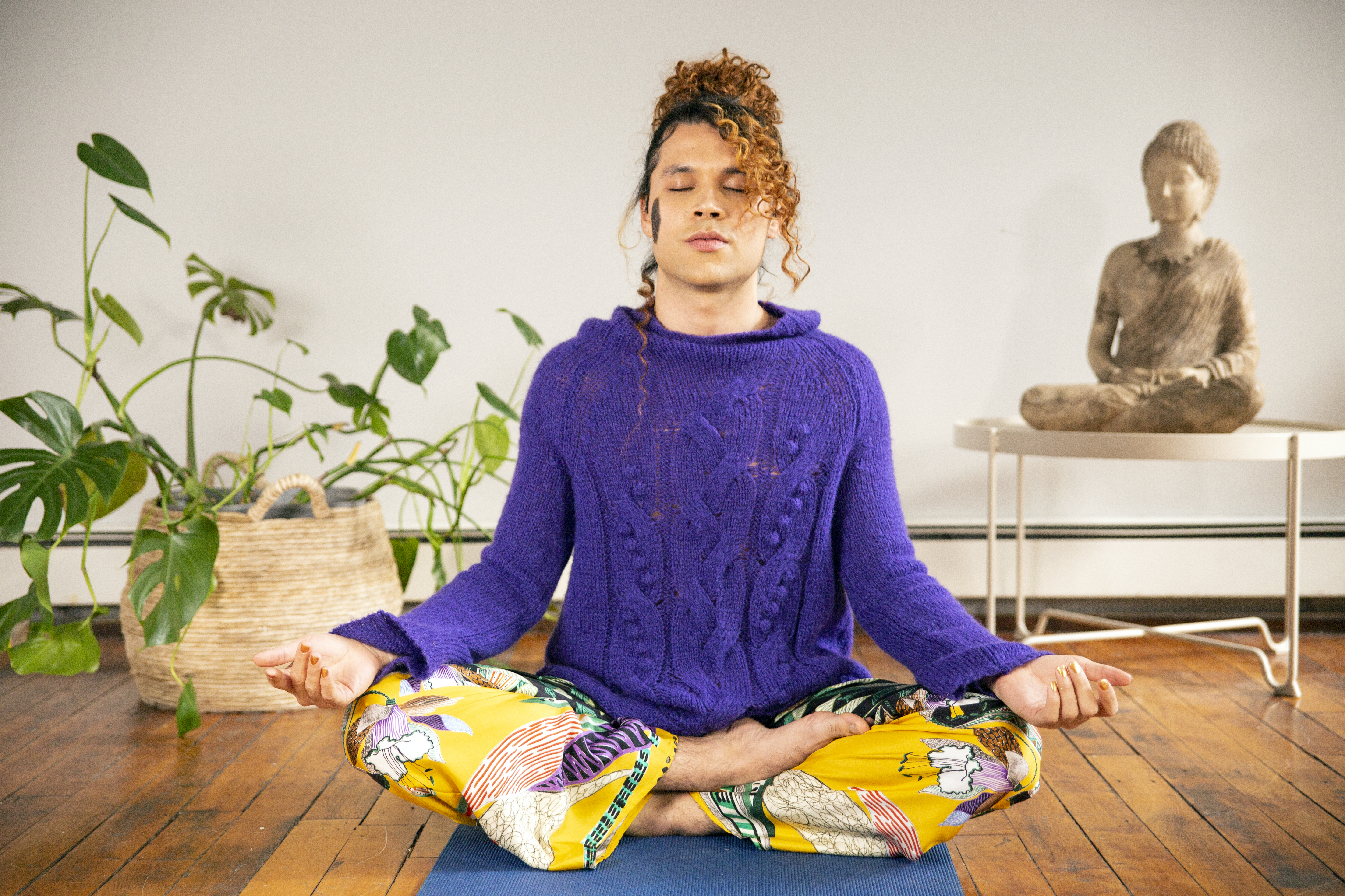 A genderfluid person meditating