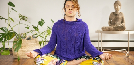 A genderfluid person meditating